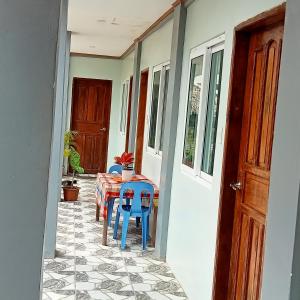 a porch with a table and chairs and a door at JANHOUR PLACE in San Vicente