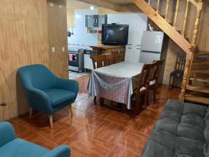 a kitchen and dining room with a table and chairs at Casa frente a la playa in Valdivia