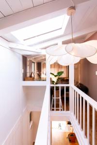 a room with white walls and a ceiling with a skylight at Bonjour Maison -Self check-in in Fukuoka