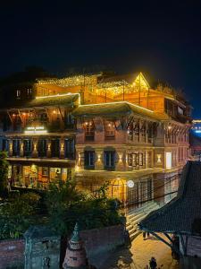 a building with lights on it at night at Hotel Empire & Rooftop Restaurant in Bhaktapur
