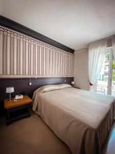 Postel nebo postele na pokoji v ubytování MH HOTEL VARAZZE