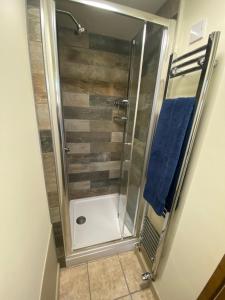 a bathroom with a shower with a glass door at Glen Farm Glamping in Cromer