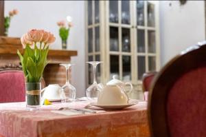 a table with a tea pot and flowers on it at Hotel Rural Cascadas de Tobera in Tobera