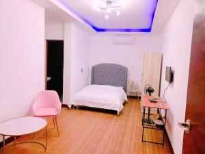 a bedroom with a bed and a table and chairs at House of Aice in El Nido