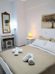 a bedroom with a large bed with towels on it at Idomeneas Apartments in Sougia