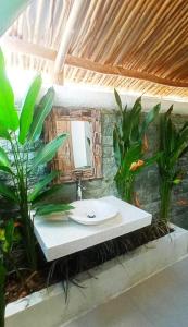 a bathroom with a sink and a mirror at Alamanda Bingin in Uluwatu