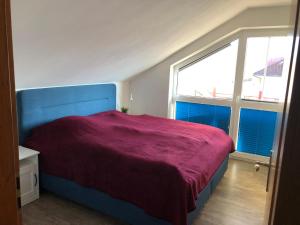 a bedroom with a large bed with a purple blanket at Bella Vista4you in Sonthofen
