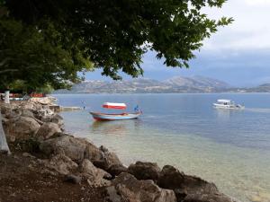 two boats in a body of water with mountains at Choo Choo Pansiyon in Egirdir