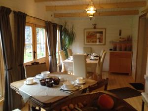 a kitchen and dining room with a table and chairs at Alice Guest house in Cheltenham