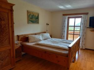 a bedroom with a wooden bed and a window at Paulbauer in St. Wolfgang