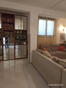 a living room with a couch and a book shelf at la casa che vorresti in Fonte Nuova