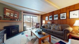 a living room with a couch and a fireplace at Summit 45 Apartment in Mammoth Lakes