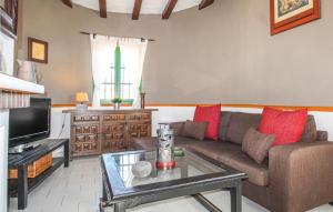 a living room with a couch and a tv at Beautiful Home In Frigiliana With Wifi, Private Swimming Pool And Swimming Pool in Frigiliana