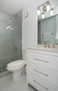 a bathroom with a toilet and a shower and a sink at Landing View 304 with rooftop terrace in Rincon