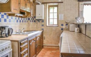 a small kitchen with a sink and a stove at Murier in Assay