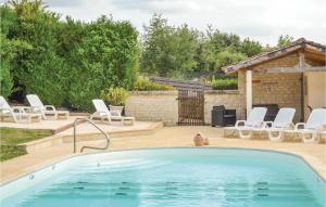 a swimming pool in a backyard with chairs and a grill at Murier in Assay