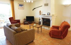 a living room with two chairs and a fireplace at Amazing Home In Cruzy in Cruzy