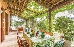 een patio met een tafel en stoelen en een pergola bij Casa Orvieto in Castel Viscardo