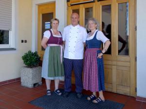 Ein Mann und zwei Frauen stehen vor einer Tür in der Unterkunft Radhotel Schischek in Oberpurkla