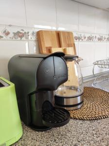 a coffee maker sitting on a counter in a kitchen at Coastal Dream - Fuseta in Fuzeta