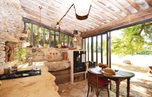a kitchen with a table and a stove and windows at 1 Bedroom Beautiful Home In Saignon in Saignon