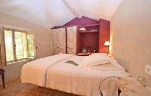 a bedroom with a large bed with purple walls at 1 Bedroom Beautiful Home In Saignon in Saignon