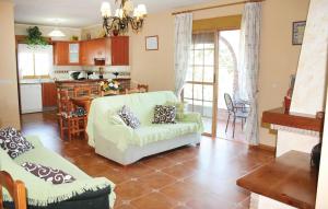 a living room with a couch and a kitchen at Lovely Home In Corumbela With House A Mountain View in Corumbela