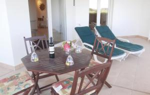 einen Holztisch mit 2 Stühlen und eine Flasche Wein in der Unterkunft Two-Bedroom Apartment Sucina Murcia With Lake View 03 in Sucina