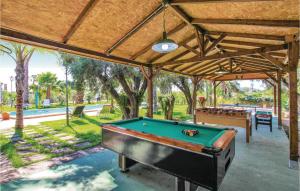 a pool table under a pavilion with a pool table at Stunning Home In La Marina, Elche in La Marina