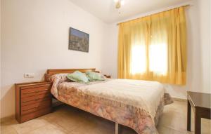 a bedroom with a bed with a dresser and a window at Stunning Home In La Marina, Elche in La Marina