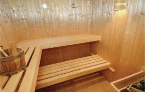a wooden sauna with a wooden bench in it at Nice Home In Salazac With Jacuzzi in Salazac