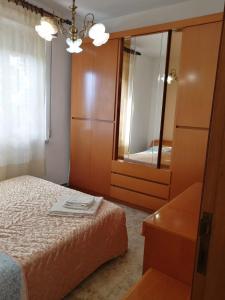 sypialnia z łóżkiem, komodą i lustrem w obiekcie Casa Giardino sul Mare w mieście Grottammare +15 zdjęć