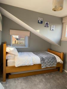 a bedroom with a bed with a staircase in it at Ivy House, three bed cottage, parking garden in Skipsea