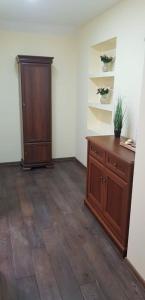 a room with a dresser and a cabinet in a room at APARTAMENTY RETRO DE LUX KROSNO in Krosno