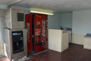 an empty room with a cocacola soda machine at Stay Express Inn Near Ft. Sam Houston in San Antonio