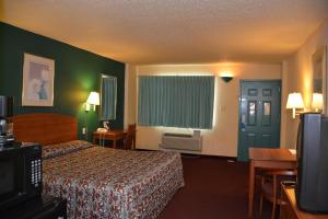 a hotel room with a bed and a television at Stay Express Inn Near Ft. Sam Houston in San Antonio