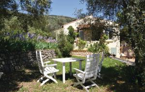 two white chairs and a table in a garden at Stunning Home In Sollies Toucas With 3 Bedrooms, Wifi And Private Swimming Pool in Solliès-Toucas