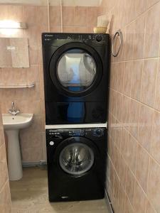 a washing machine in a bathroom with a sink at Grand'Roche in Cornimont