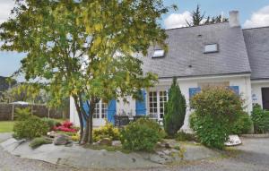 a white house with a tree in front of it at Holiday Home Penestin Chemin De Camaret in Pénestin