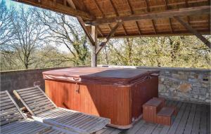 a wooden hot tub and two chairs on a deck at Cozy Home In Padiracbascoul With Wifi in Padirac +15 photos