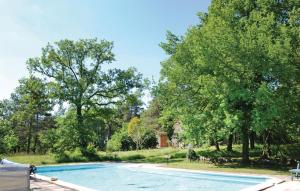 a swimming pool in a yard with trees at Awesome Home In Sers With Kitchen in Sers