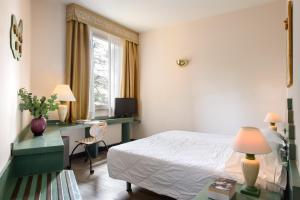 Voodi või voodid majutusasutuse Grand Hotel Panoramic toas