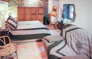 a bedroom with two beds and a couch at 1 Bedroom Gorgeous Home In Thueyts in Thueyts