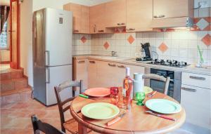 a kitchen with a wooden table and a refrigerator at 1 Bedroom Gorgeous Home In Thueyts in Thueyts