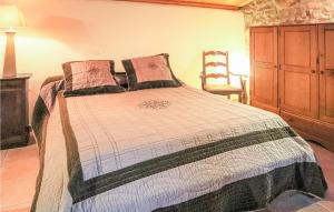 a bedroom with a bed and a wooden cabinet at 1 Bedroom Gorgeous Home In Thueyts in Thueyts +3 photos