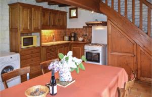 a kitchen with a table with flowers on it at Le Clos Des Tilleuls in Ligré
