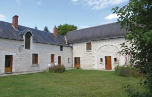 a large white building with a large yard at Le Clos Des Tilleuls in Ligré