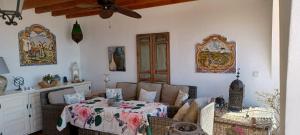 a living room with a table and a couch at Casa Roble B&B in Cómpeta