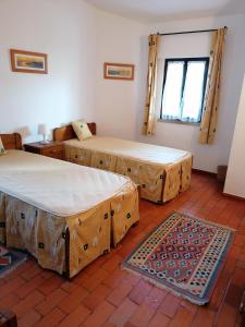 a room with two beds and a rug at Villa 88 in Almancil +31 photos