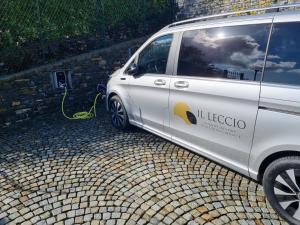 a white van parked next to a wall with a hose at Il Leccio - Luxury Resort Portofino Monte in Santa Margherita Ligure